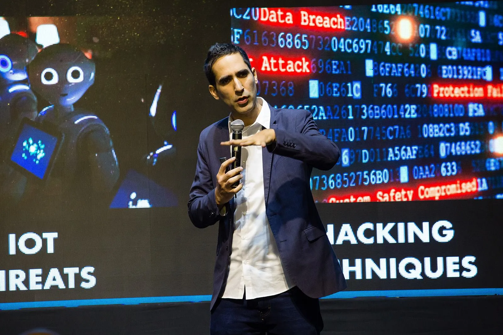 Menny Barzilay on stage in Portugal, presenting IoT threats and hacking techniques